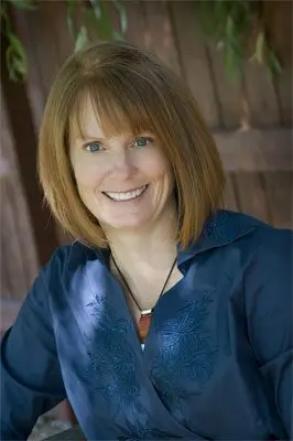 Julie Uhernik outdoors in a blue embroidered blouse